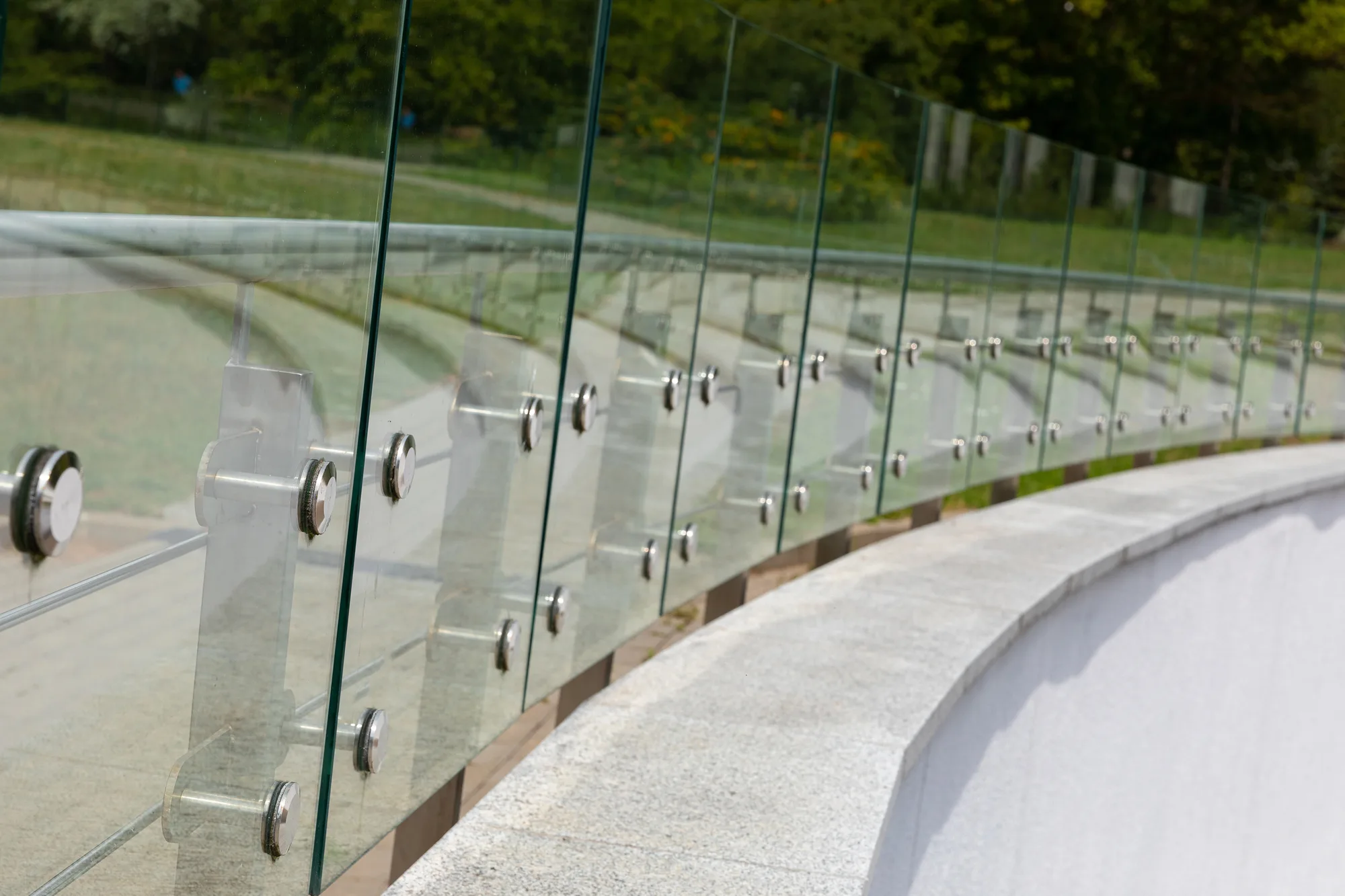 Curved frameless glass fence panels on stainless steel spigots