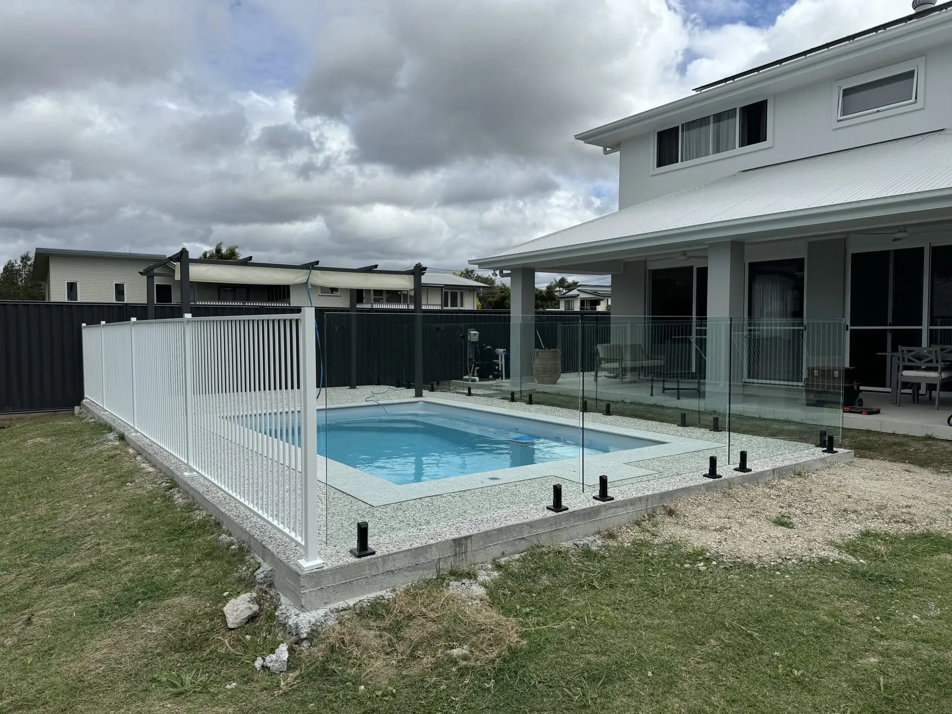 Newly installed frameless glass fence around a plunge pool