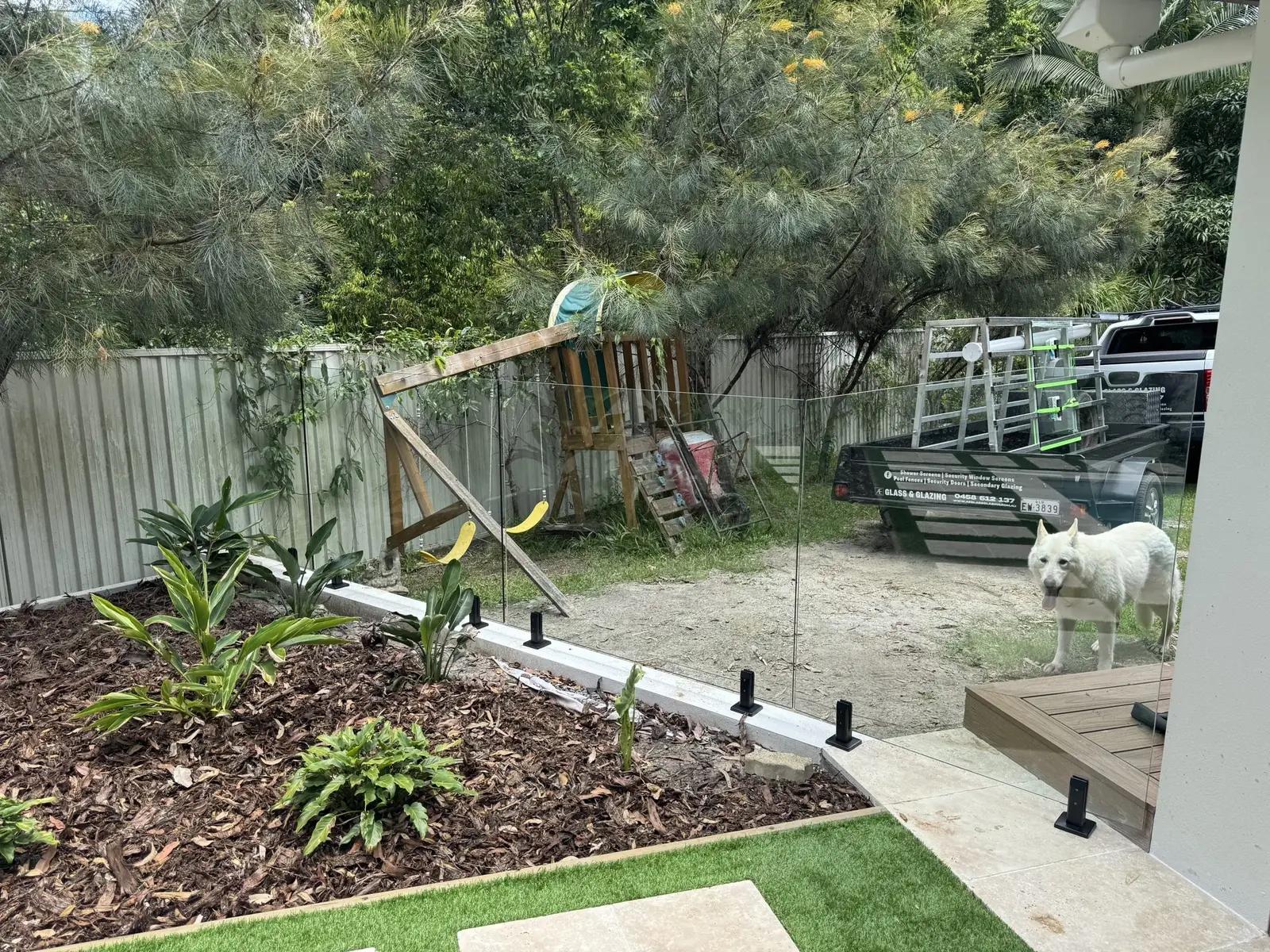 Pool fence spigot posts set into a landscaped garden bed